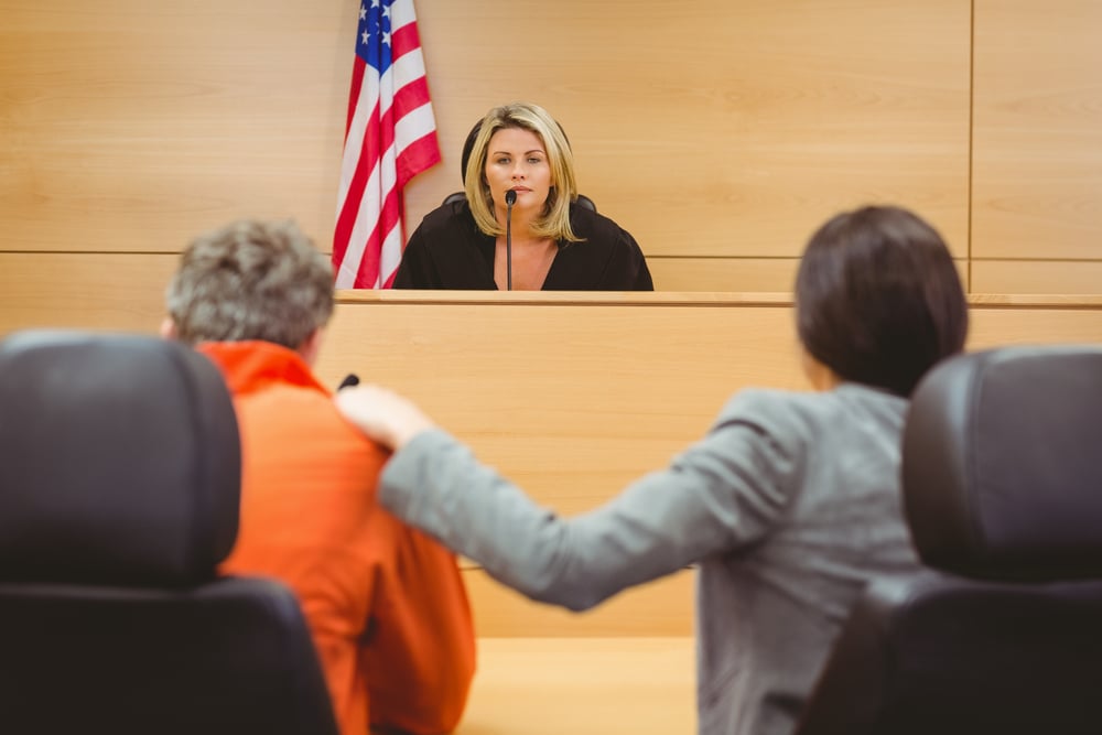 Judge and lawyer discussing the sentence for prisoner in the court room image