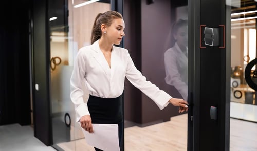Woman in white blouse using the Rock to enter an office