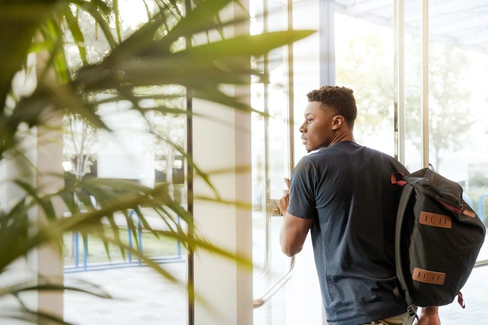 Student exiting housing dorm 