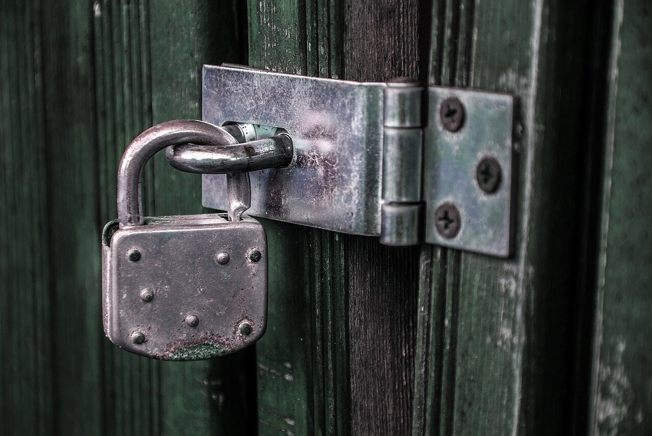 Padlock on green door