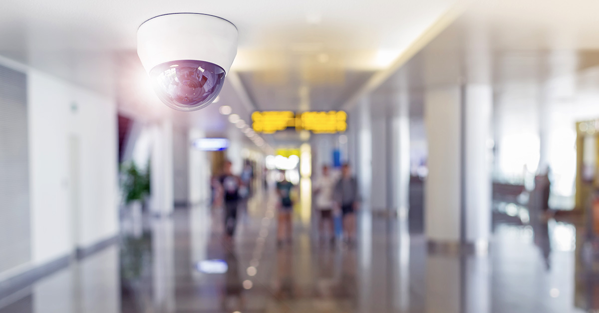 Surveillance camera monitoring a busy hallway