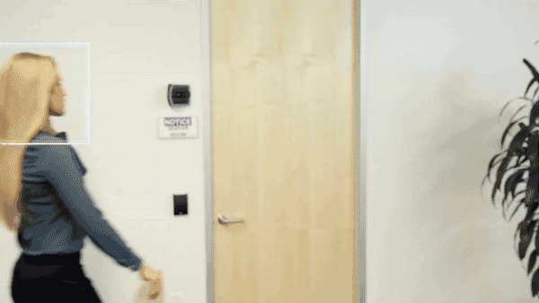Gif of a person being tailgated through a door in a corporate environment.